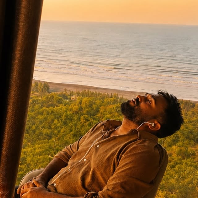 Prashant relaxing beside a sunlit sea view